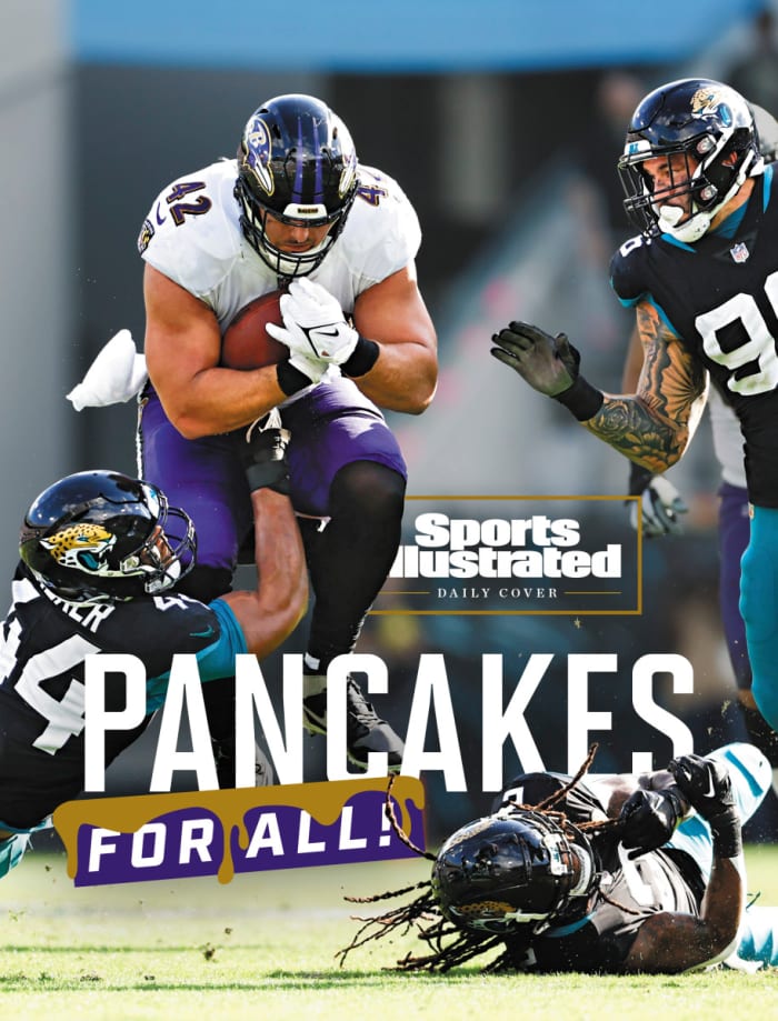 Pat Ricard leaps as he runs through the Jaguars defense